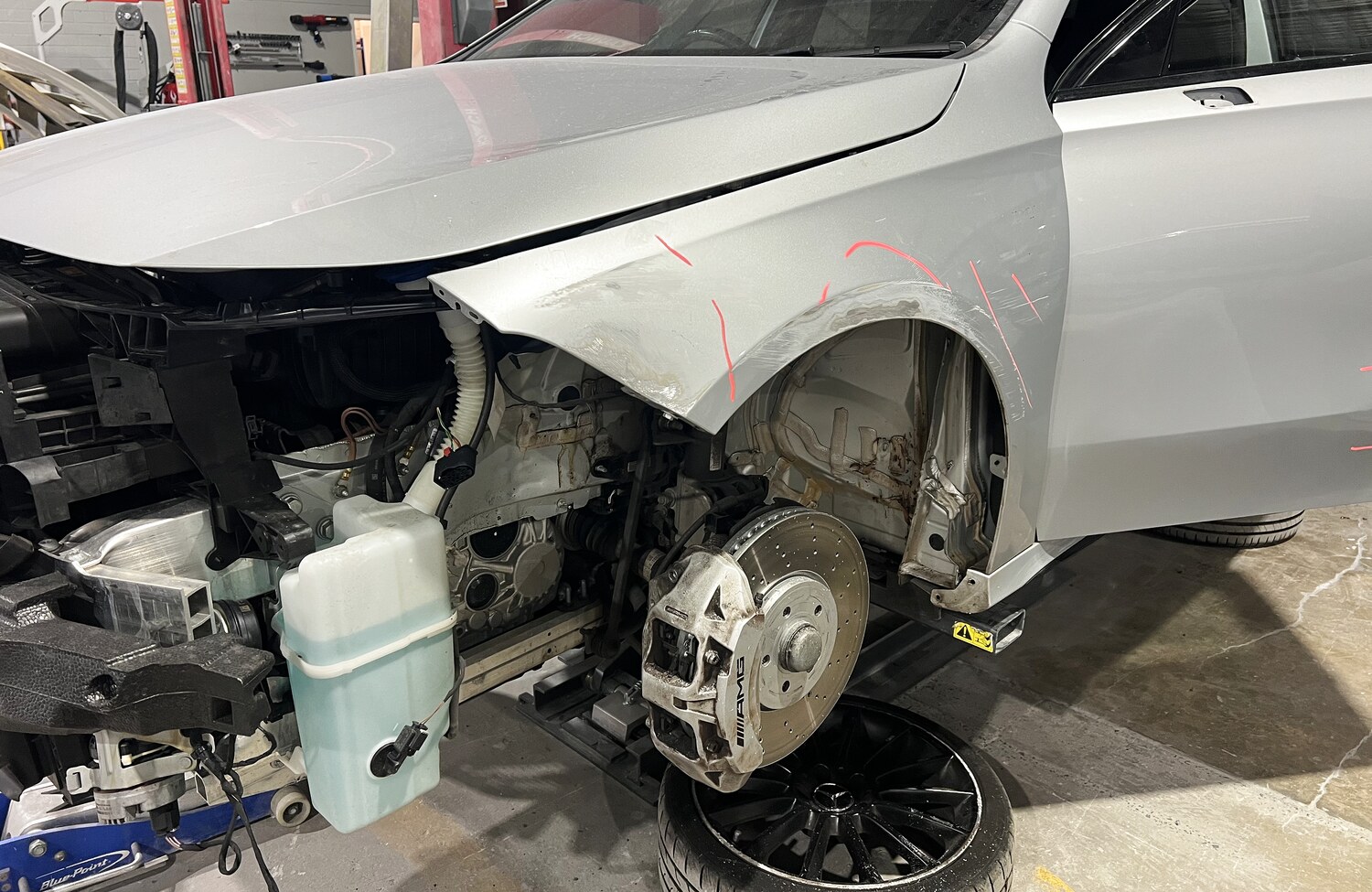 Close-up of panel repair and AMG brakes on a Mercedes at All Gosford Smash Repairs