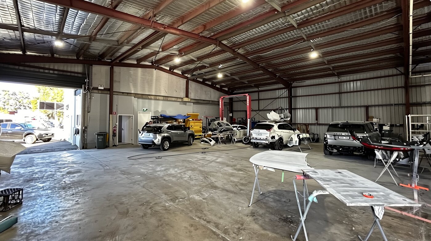 The All Gosford Smash Repairs workshop floor with panels in paint prep